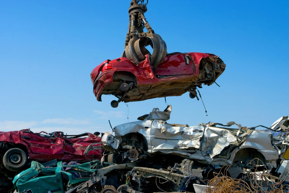 Crane picking up a car in a junkyard